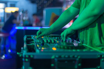 Fototapeta na wymiar DJ mixing in a karaoke bar. Soft focus on hand - a concept of entertainment, youth, entertainment and relaxation