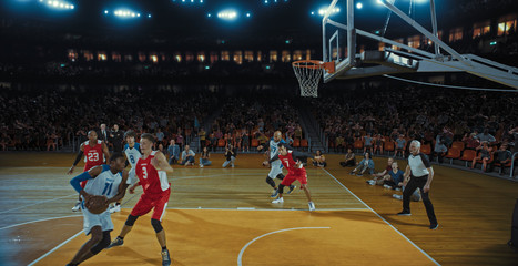 Basketball players on big professional arena during the game. Tense moment of the game. Celebration