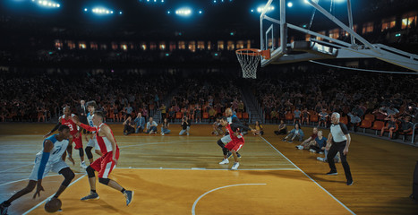 Basketball players on big professional arena during the game. Tense moment of the game. Celebration