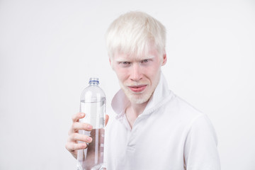 portrait of an albino man in  studio dressed t-shirt isolated on a white background. abnormal...