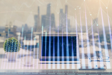 Fototapeta na wymiar Forex Chart hologram on table with computer background. Multi exposure. Concept of financial markets.