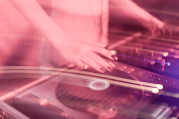 Fototapeta na wymiar DJ mixing in a karaoke bar. Soft focus on hand - a concept of entertainment, youth, entertainment and relaxation