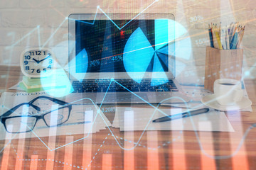 Financial market graph hologram and personal computer on background. Double exposure. Concept of forex.