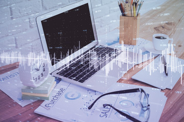 Financial market graph hologram and personal computer on background. Double exposure. Concept of forex.