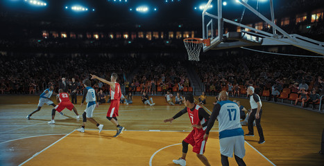 Basketball players on big professional arena during the game. Tense moment of the game. Celebration