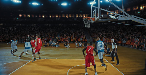 Fototapeta premium Basketball players on big professional arena during the game. Tense moment of the game. Celebration