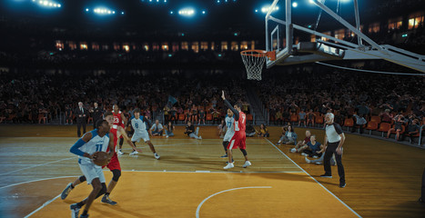 Fototapeta premium Basketball players on big professional arena during the game. Tense moment of the game. Celebration