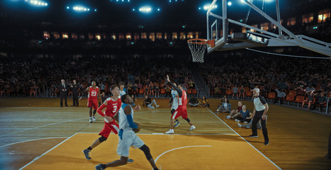 Fototapeta premium Basketball players on big professional arena during the game. Tense moment of the game. Celebration