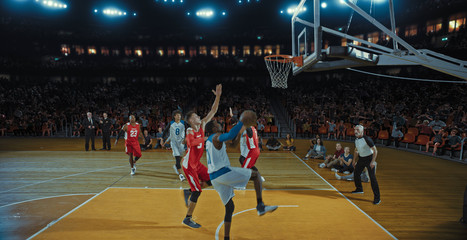 Obraz premium Basketball players on big professional arena during the game. Tense moment of the game. Celebration