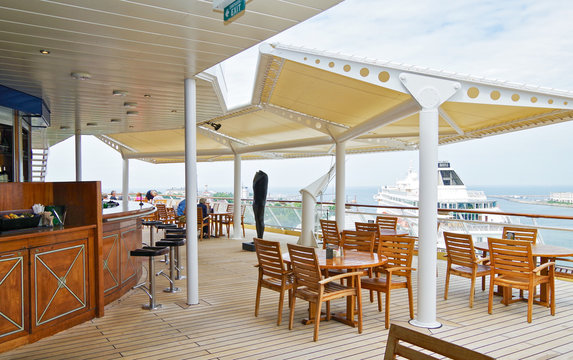 Outdoor Terrace Or Patio With Seating And Bar On Luxury Celebrity Cruise Ship Cruiseship  Liner With Al Fresco Dining From Buffet Self-service Venue