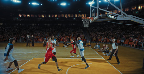 Basketball players on big professional arena during the game. Tense moment of the game. Celebration