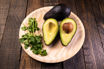 Avocado split in half on wood. Healthy and vegetarian food
