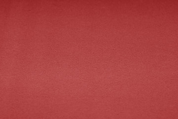 Plastic glittering texture with blur effect in red color.
