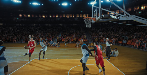 Fototapeta premium Basketball players on big professional arena during the game. Tense moment of the game. Celebration