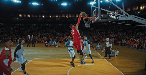 Fototapeta premium Basketball players on big professional arena during the game. Tense moment of the game. Celebration