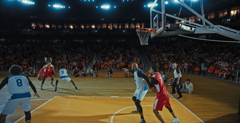 Fototapeta premium Basketball players on big professional arena during the game. Tense moment of the game. Celebration