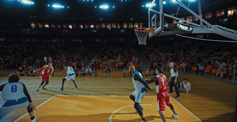Fototapeta premium Basketball players on big professional arena during the game. Tense moment of the game. Celebration