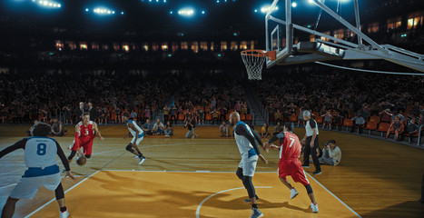 Fototapeta premium Basketball players on big professional arena during the game. Tense moment of the game. Celebration