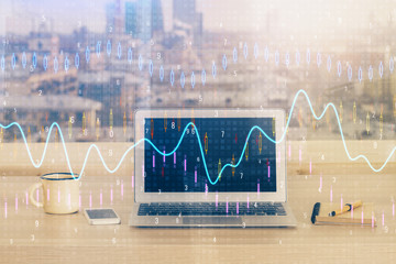 Financial graph colorful drawing and table with computer on background. Double exposure. Concept of international markets.