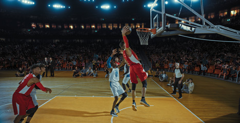 Fototapeta premium Basketball players on big professional arena during the game. Tense moment of the game. Celebration