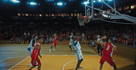 Basketball players on big professional arena during the game. Tense moment of the game. Celebration