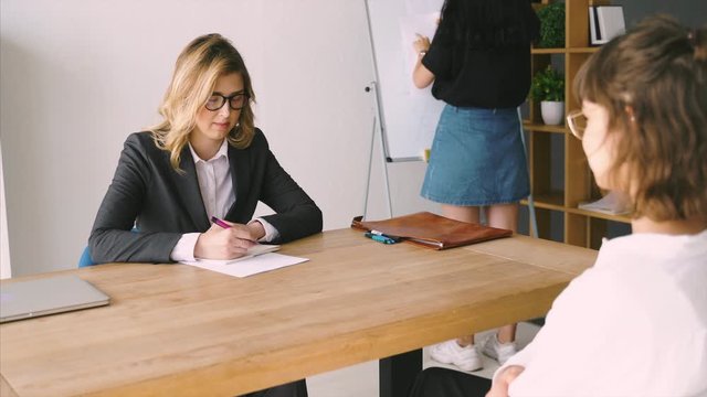Young female candidate interviewed by employer