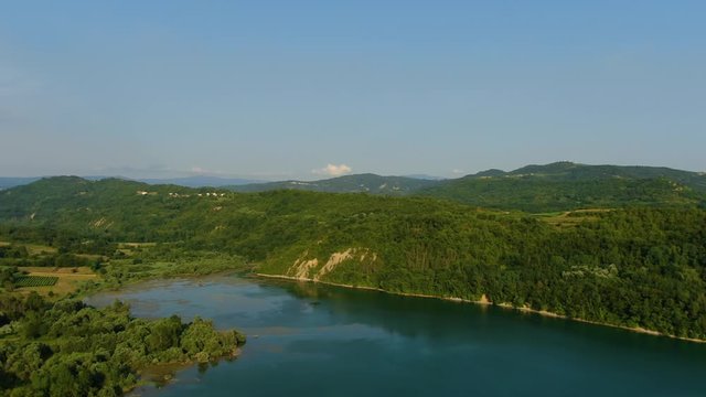 Lake Butoniga water dam in Croatia shore approach, Aerial drone left pan reveal shot