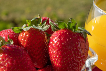 glass of healthy tropical cocktail and strawberries