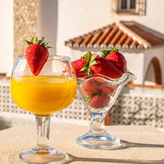 glass of healthy tropical cocktail and strawberries