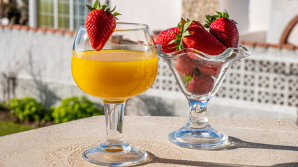 glass of healthy tropical cocktail and strawberries