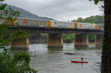 Fototapeta premium Train Crossing a Bridge in Harpers Ferry