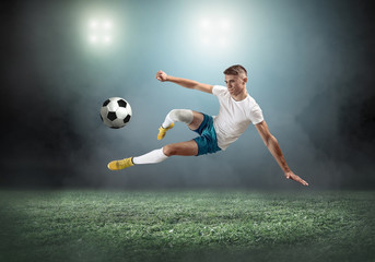 Soccer player on a football field in dynamic action at summer da