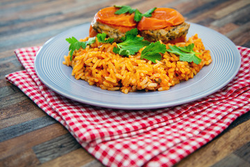 stuffed tomatoes with rice on a white plate