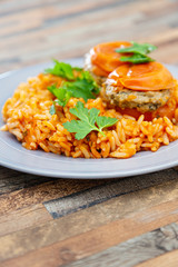 stuffed tomatoes with rice on a white plate