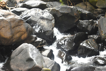 a stream of water falling between the rocks