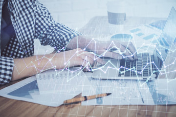 Multi exposure of stock market chart with man working on computer on background. Concept of financial analysis.