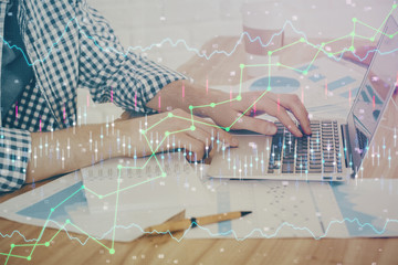 Multi exposure of stock market chart with man working on computer on background. Concept of...