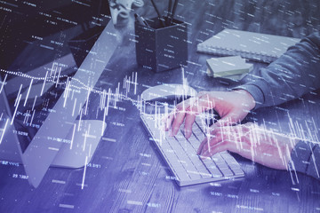 Double exposure of financial graph with man works in office on background. Concept of analysis.