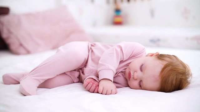 cute little baby girl sleeping peacefully in bed