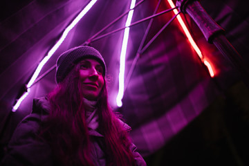 Woman portrait at night in neon light