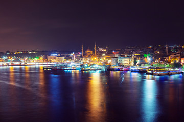 Night view of illuminated Galata bridge with Suleymaniye Camii, Istanbul, Turkey
