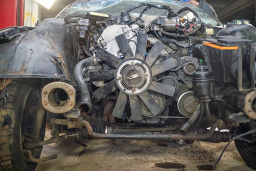 Semi-disassembled car after an accident close-up on the auto Assembly. Concept of car service, auto Assembly, used auto parts