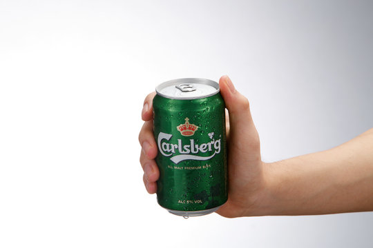 Hand Holding Carlsberg Beer Can