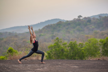 Fototapeta premium Girl preforming yoga in India at sunset