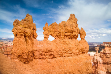 Fototapeta na wymiar Eroded Hoodoo rocks, or according to Native American nation legend - people turned into pinnacles. Bryce Canyon National Park, Utah, USA. Pink orange desert sand and stone Colorado Plateau landscape