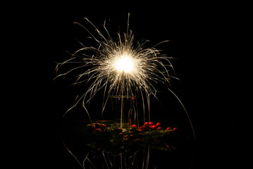Sparkler burns at night in the interior.