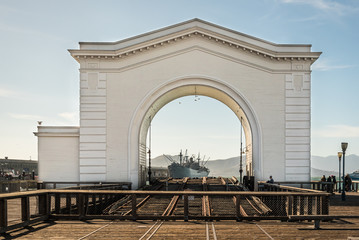 Old Port Gate 43 and historic WW2 military cargo U.S. Liberty ship Jeremiah O Brien Museum at Pier 45, Fishermans Wharf, San Francisco, California, USA. SF Tourist destination, close to famous Pier 39