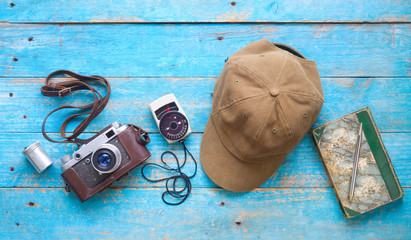 old analog camera, light meter,film can, cap and notebook with pen, photography, vintage photo gear...