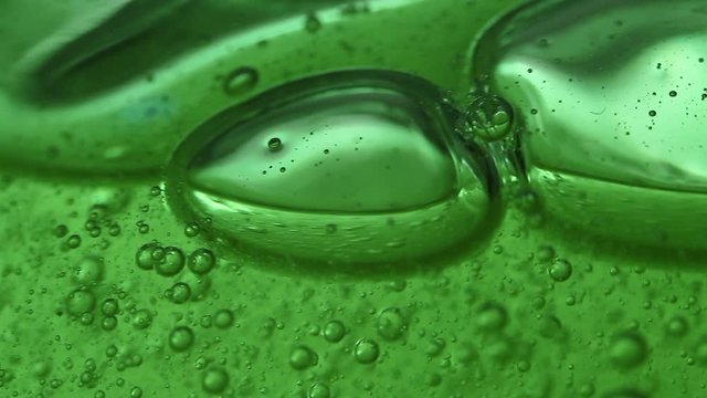 Macro of a green gel and its bubbles. Jelly. Chemistry.