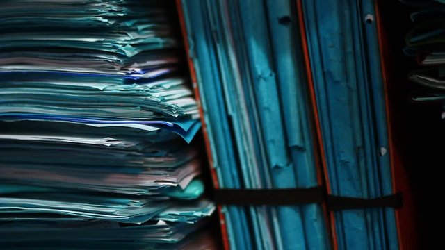 Stacks of old documents in the old archive. Brown, old data files.